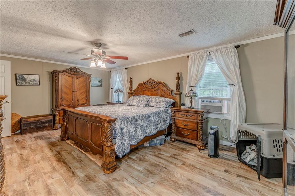 1039 Old Cedartown Road Rockmart, GA 30153 - Photo 28 of 40 a bedroom with a bed and a chandelier