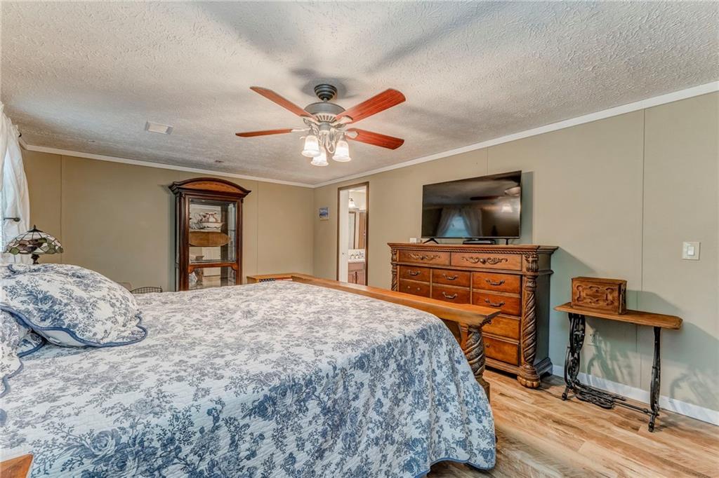 1039 Old Cedartown Road Rockmart, GA 30153 - Photo 29 of 40 a bedroom with a bed and a flat screen tv