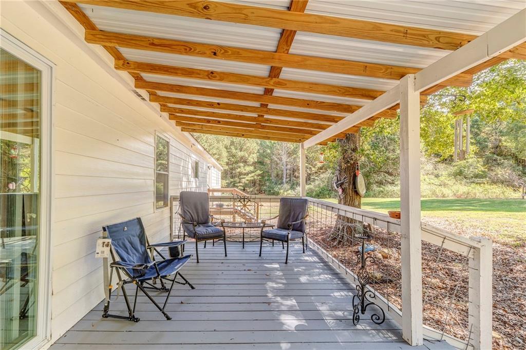 1039 Old Cedartown Road Rockmart, GA 30153 - Photo 40 of 40 a balcony with furniture and wooden floor
