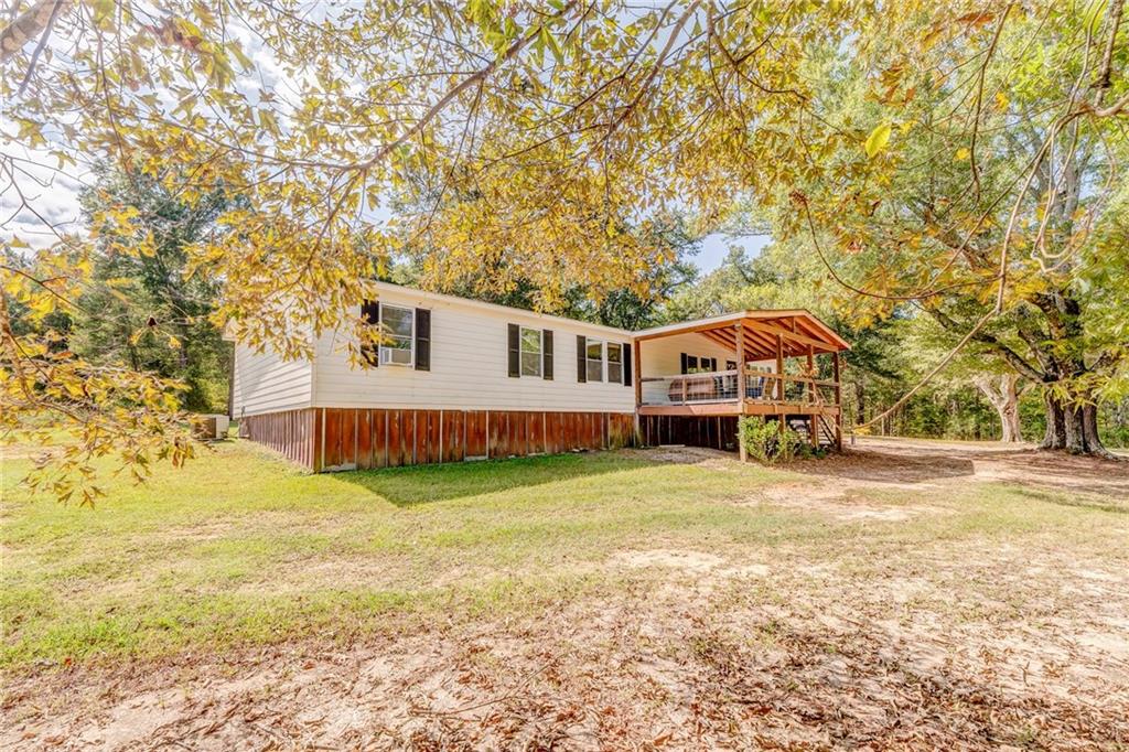 1039 Old Cedartown Road Rockmart, GA 30153 - Photo 6 of 40 a house view with a garden space