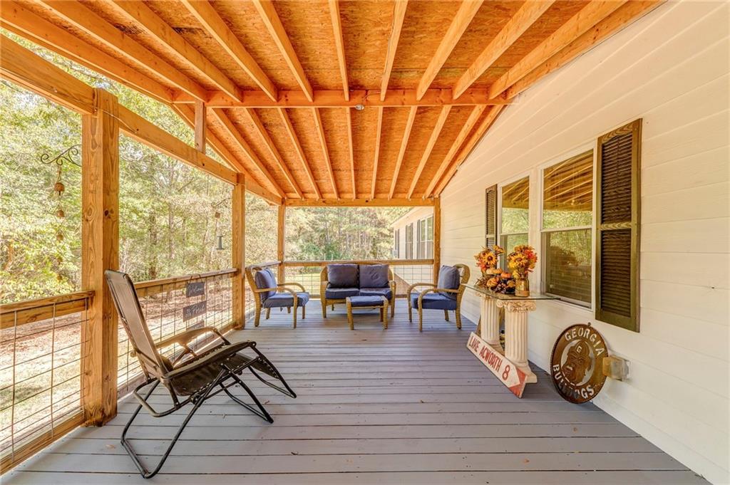 1039 Old Cedartown Road Rockmart, GA 30153 - Photo 8 of 40 a living room with furniture a wooden floor and next to a window