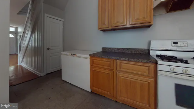 a kitchen with granite countertop cabinets stainless steel appliances and a sink