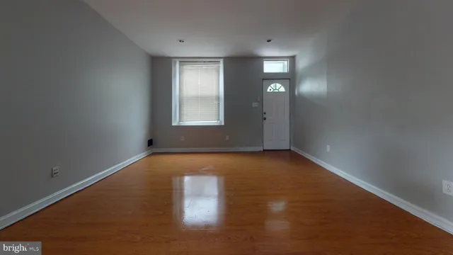 an empty room with windows and entrance