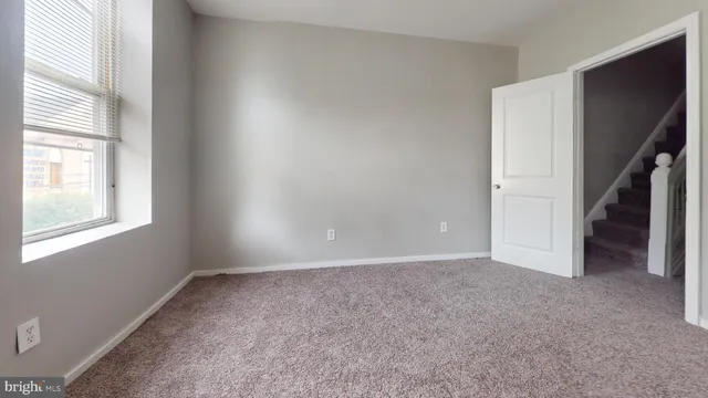 a view of an empty room with a window