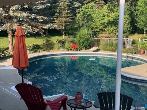 14017 North Belsay Road Millington, MI 48746 - Photo 34 of 43 View of swimming pool featuring a patio