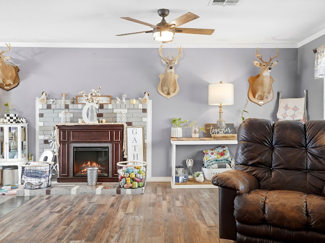 30063 South 4300th Road Stigler, OK 74462 - Photo 17 of 58 Wood-finish flooring, ceiling fan with integrated lighting, fireplace with a tile surround and dark wood mantel, and crown molding