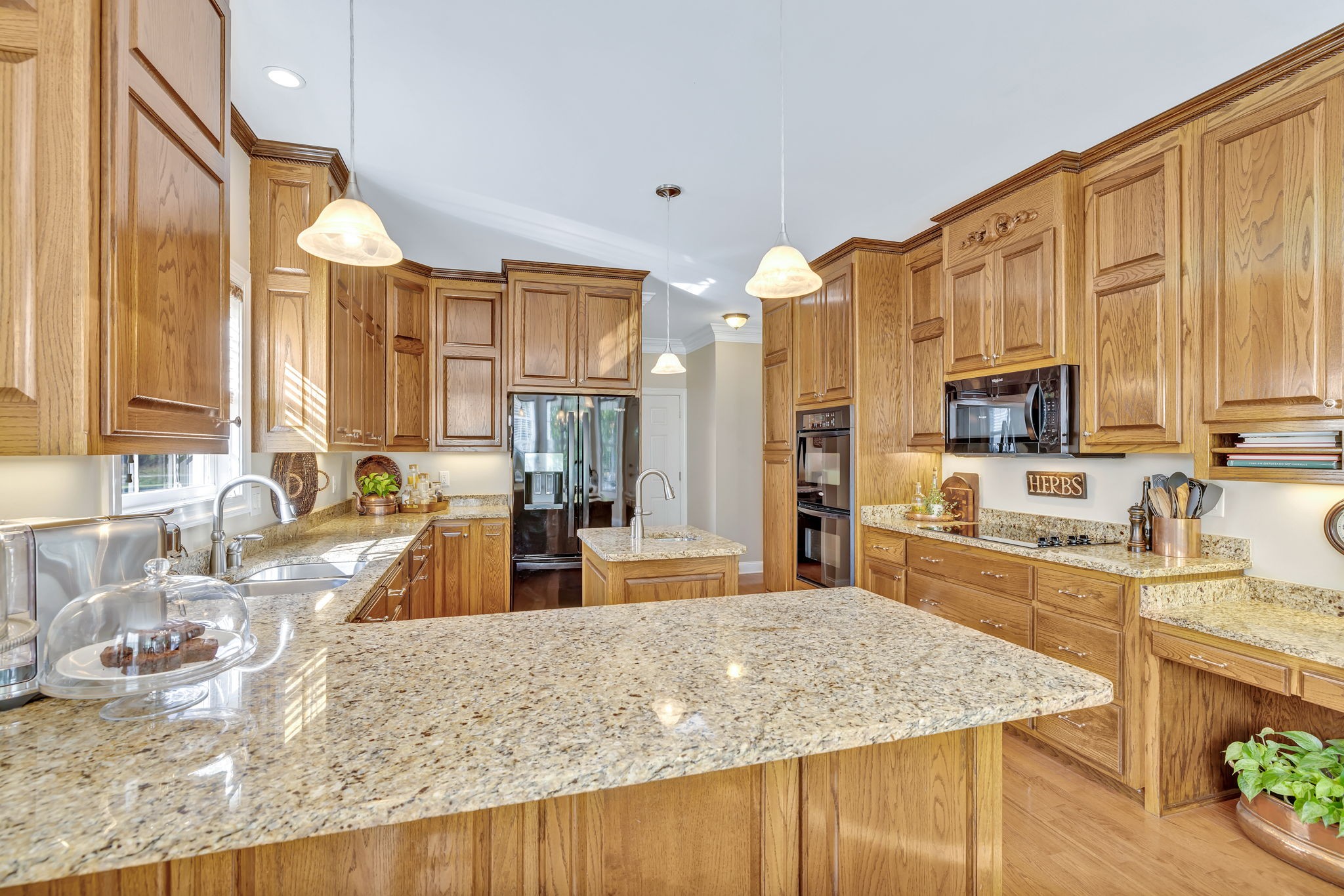 3917 Buck Matthews Road Columbia, TN 38401 - Photo 21 of 60 a large kitchen with granite countertop a large counter top cabinets and stainless steel appliances
