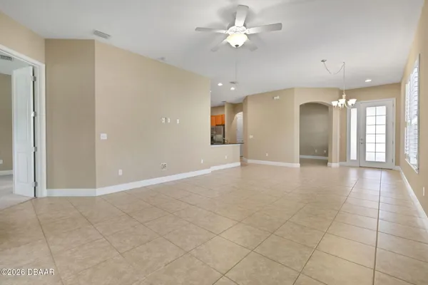 a view of an empty room and a ceiling fan