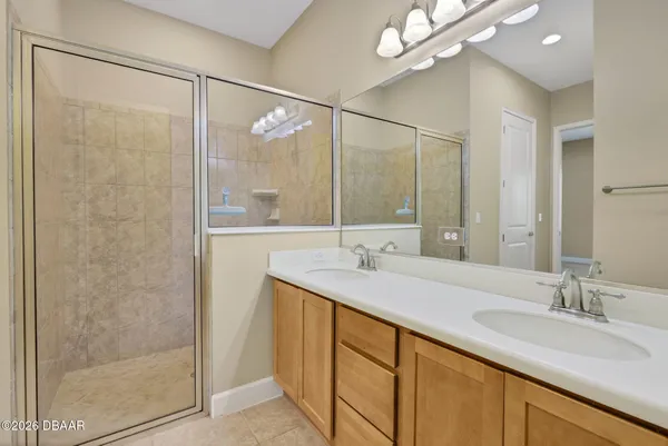 a bathroom with a shower sink and mirror