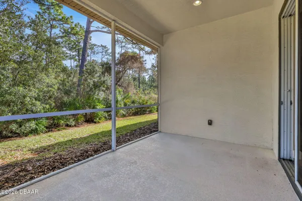 a view of a room with a small yard and wooden fence