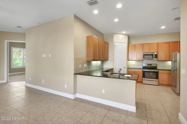 a kitchen with stainless steel appliances granite countertop a sink and cabinets