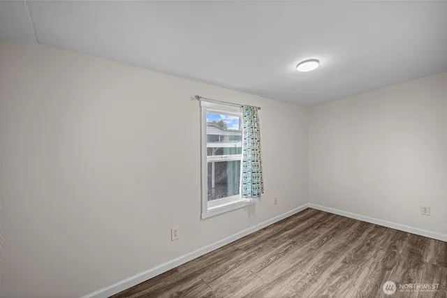 a view of wooden floor and windows in a room