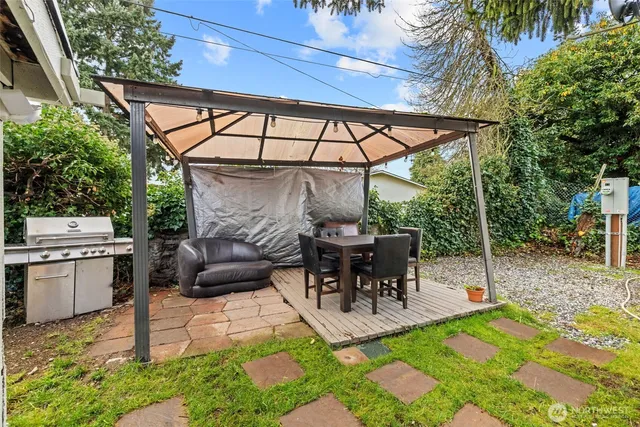 a view of a patio with table and chairs potted plants with wooden floor