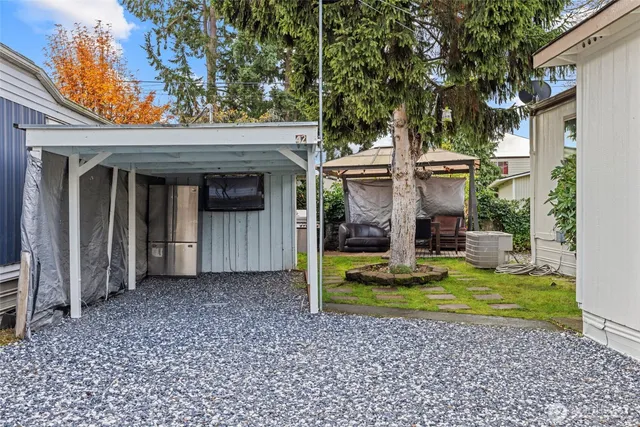 a view of a house with backyard porch and sitting area
