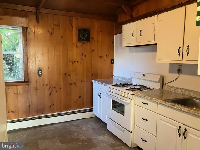 a kitchen with stainless steel appliances granite countertop a stove and a refrigerator