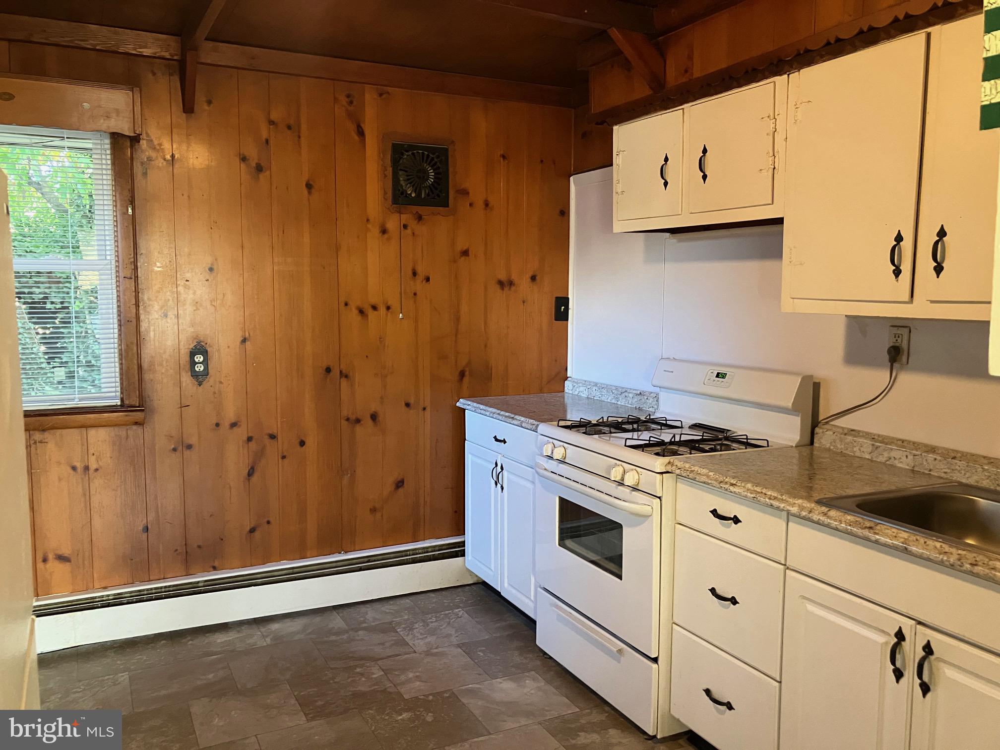 1028 Mantua Pike, Unit D Wenonah, NJ 08090 - Photo 6 of 10 a kitchen with stainless steel appliances granite countertop a stove and a refrigerator
