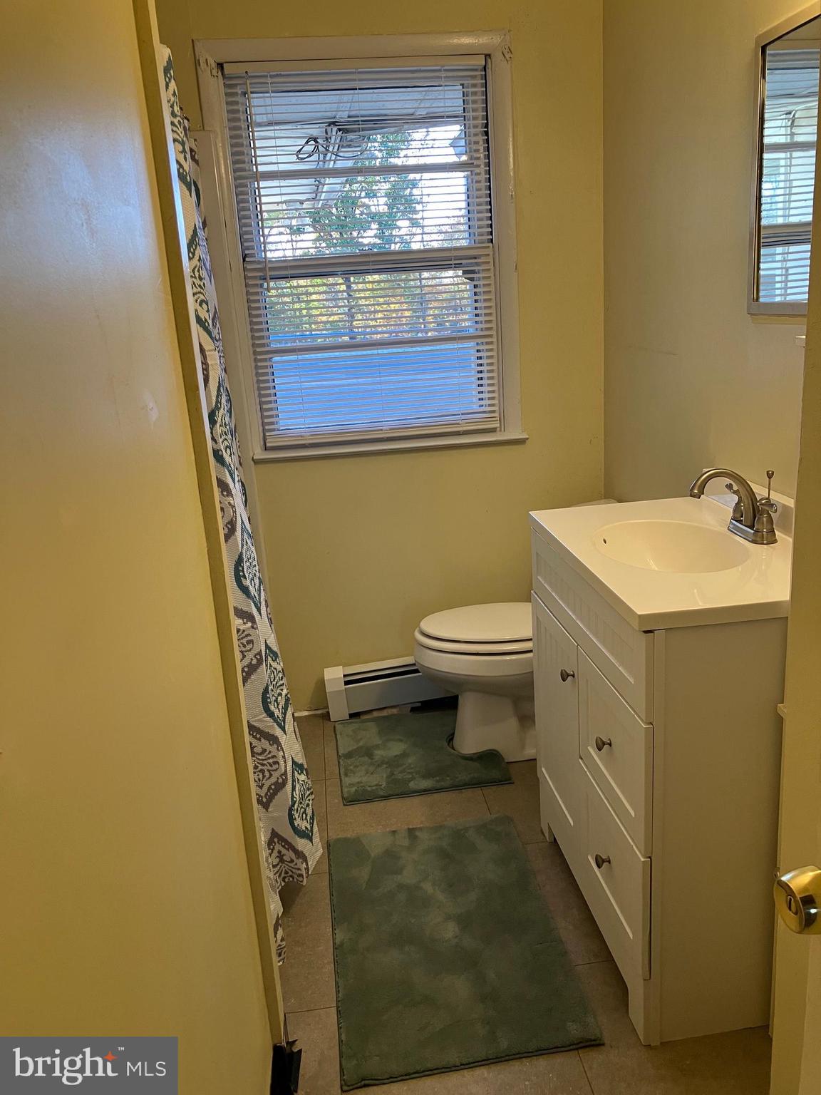 1028 Mantua Pike, Unit D Wenonah, NJ 08090 - Photo 9 of 10 a bathroom with a sink and a mirror