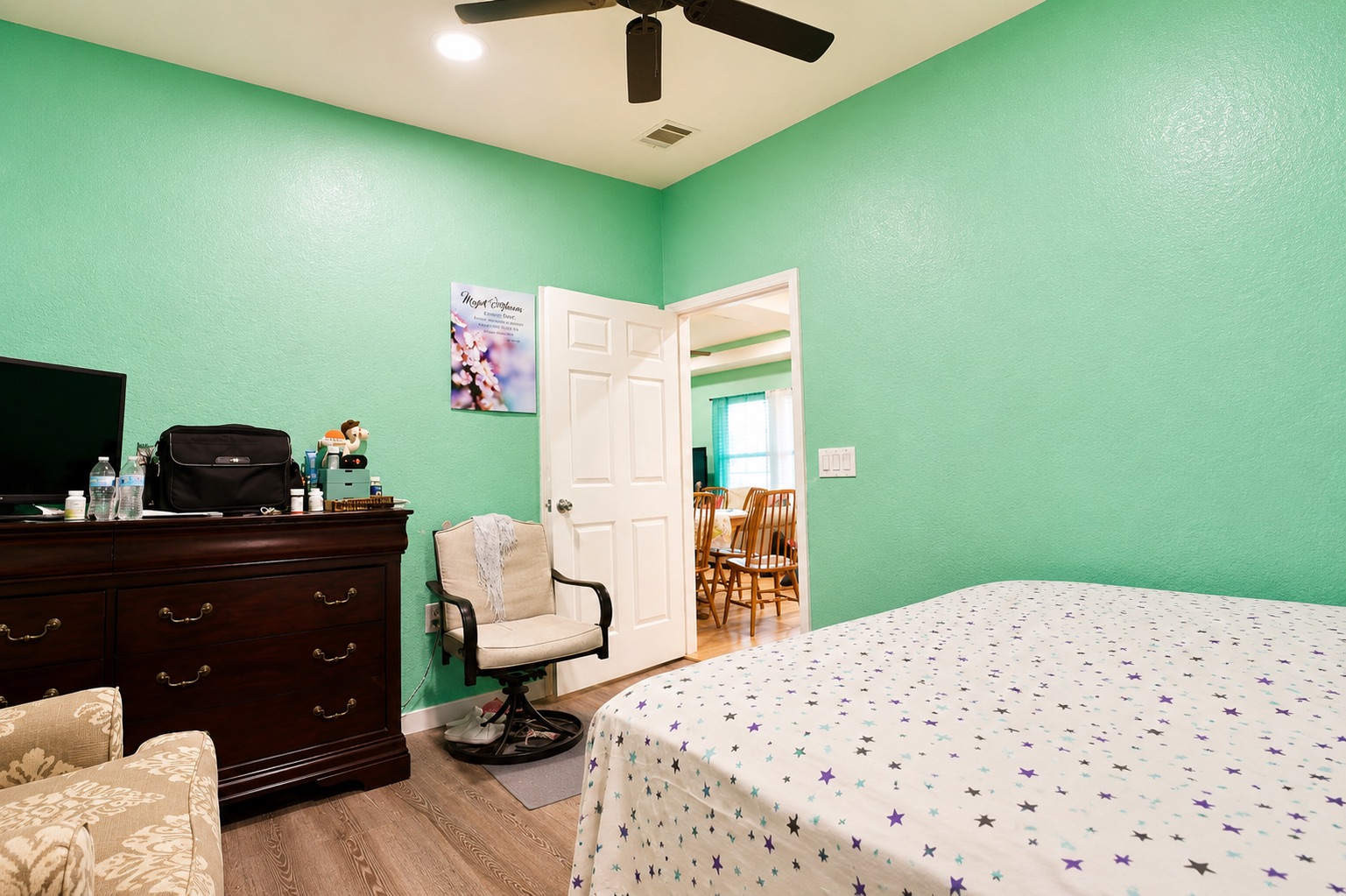 130 Los Arcos Road Elgin, TX 78621 - Photo 26 of 39 A well-lit bedroom features wood-look flooring and a ceiling fan for comfort.