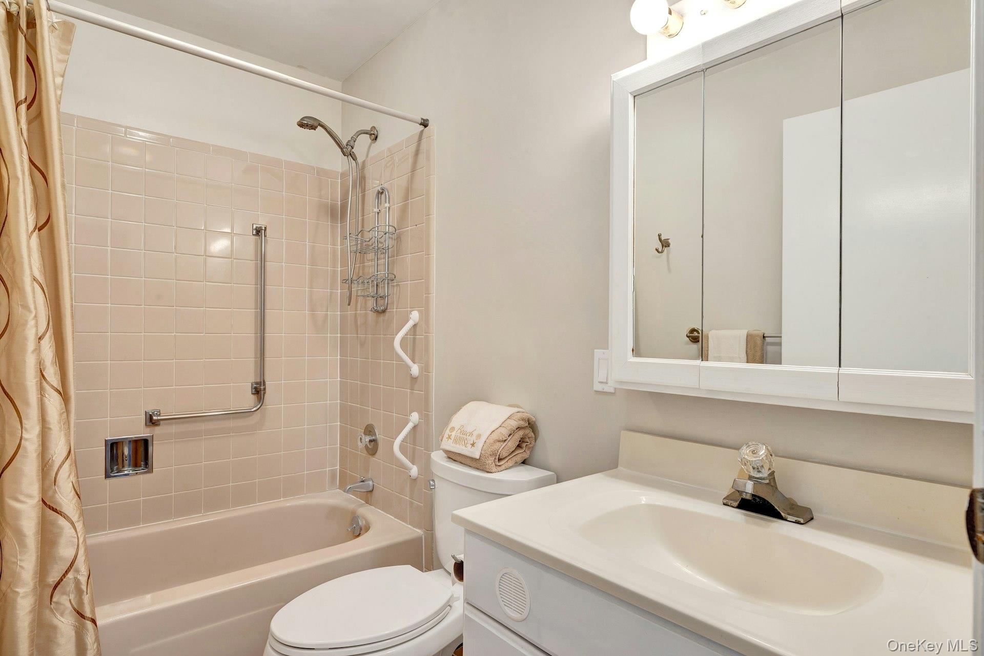 164 Falmouth Court, Unit E Ridge, NY 11961 - Photo 15 of 15 a bathroom with a sink toilet and shower