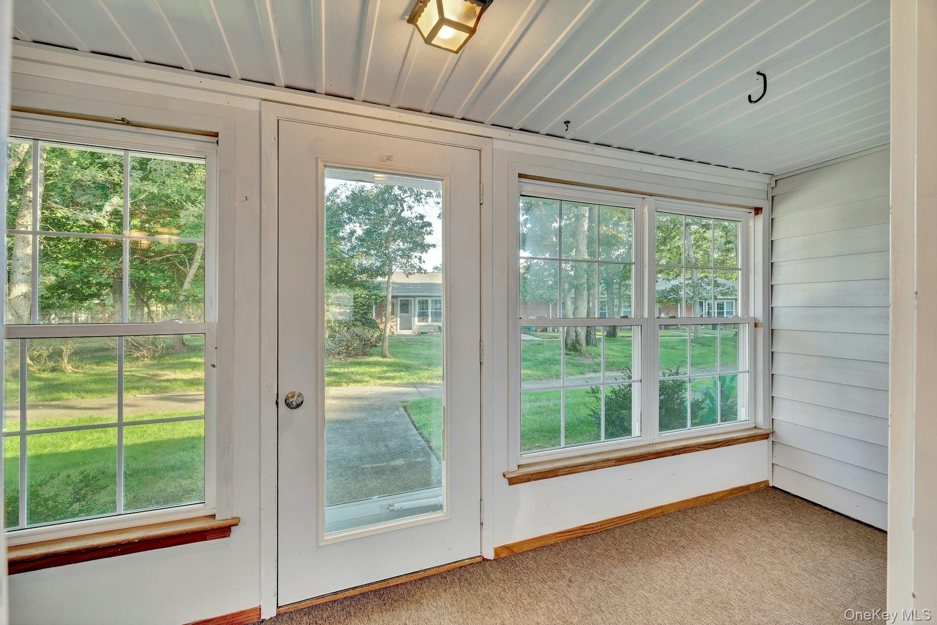 164 Falmouth Court, Unit E Ridge, NY 11961 - Photo 5 of 15 a view of a room that has a large window