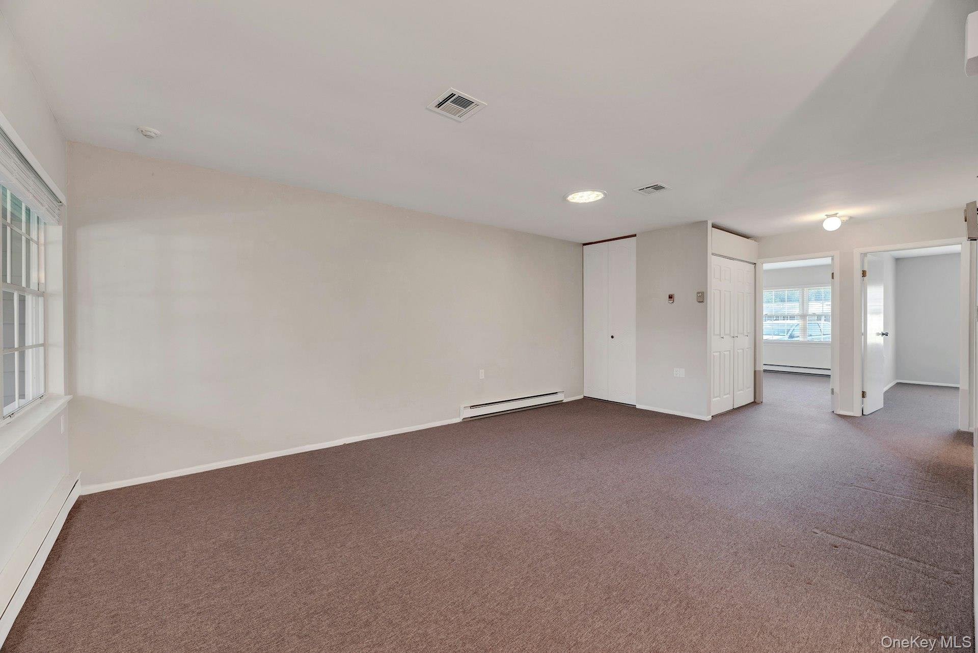 164 Falmouth Court, Unit E Ridge, NY 11961 - Photo 7 of 15 a view of an empty room