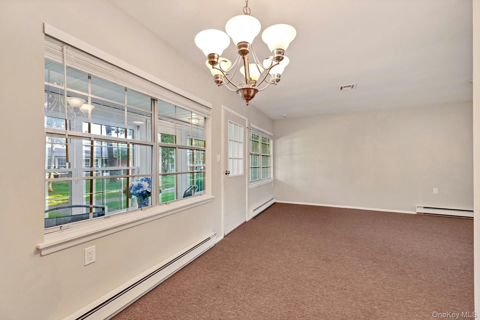 164 Falmouth Court, Unit E Ridge, NY 11961 - Photo 8 of 15 a view of livingroom with windows