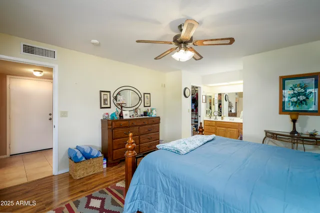 a bedroom with a bed and wooden floor
