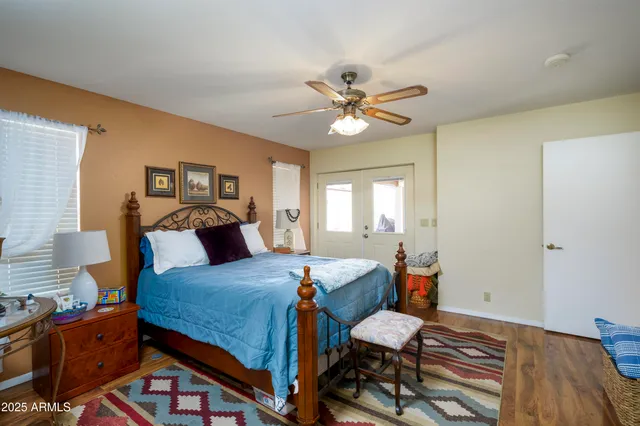 a bedroom with a bed and wooden floor