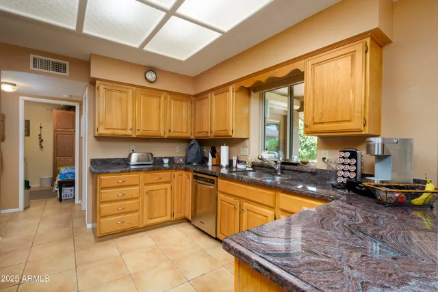 a kitchen with a sink a stove and cabinets