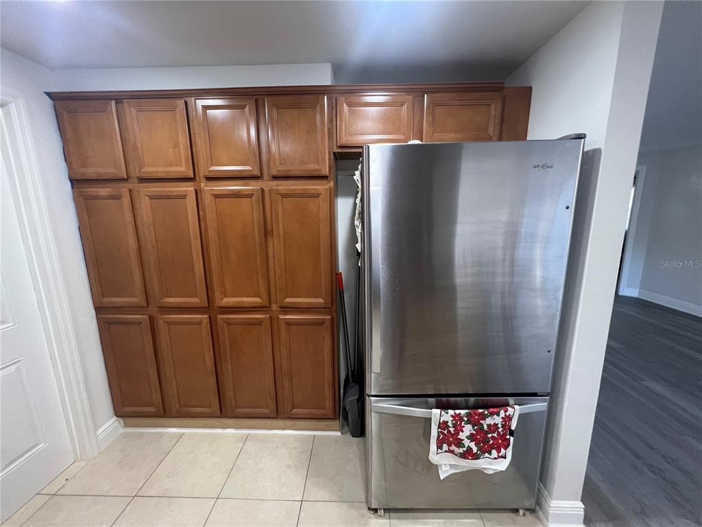 6314 Seabreeze Drive Port Richey, FL 34668 - Photo 11 of 46 a view of a refrigerator in kitchen and a wooden floor