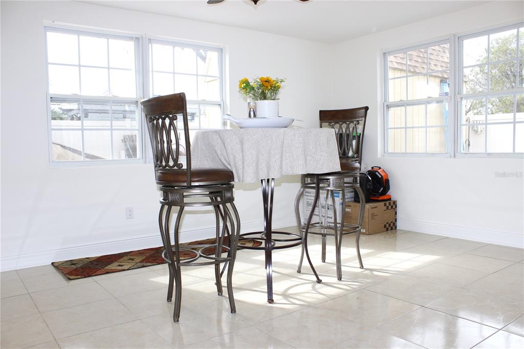 6314 Seabreeze Drive Port Richey, FL 34668 - Photo 15 of 46 a view of a dining room with furniture and a window
