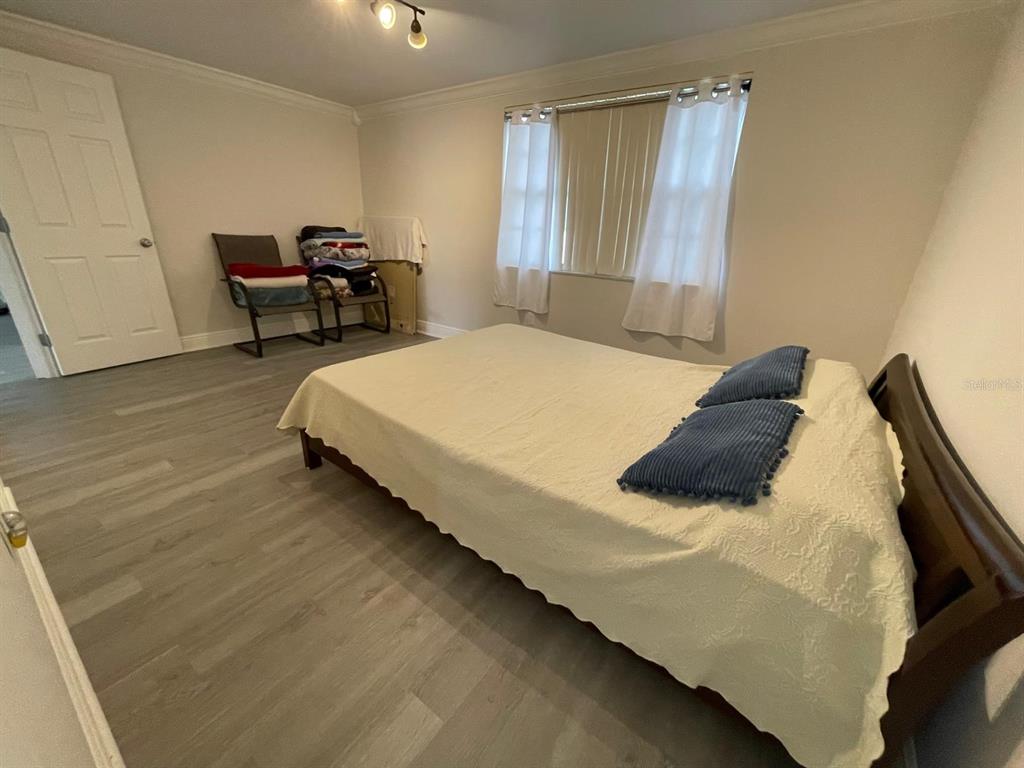 6314 Seabreeze Drive Port Richey, FL 34668 - Photo 17 of 46 a bedroom with a bed and a chair