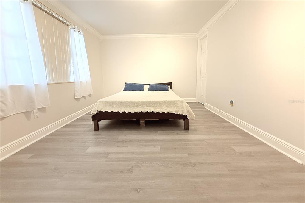 6314 Seabreeze Drive Port Richey, FL 34668 - Photo 18 of 46 a spacious bedroom with a bed and a window