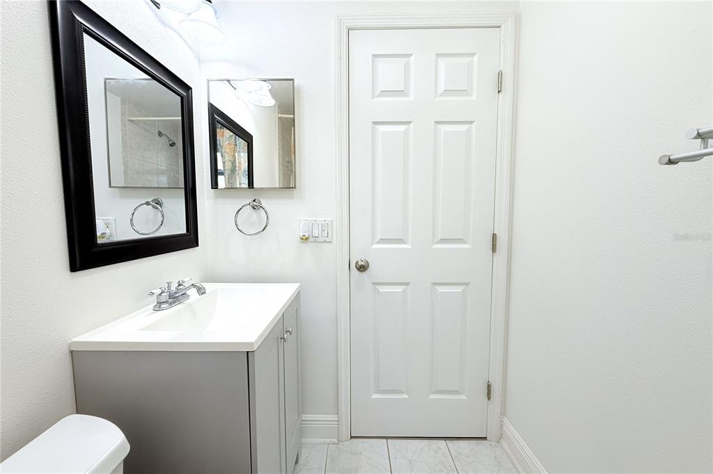 6314 Seabreeze Drive Port Richey, FL 34668 - Photo 20 of 46 a bathroom with a toilet a sink and mirror