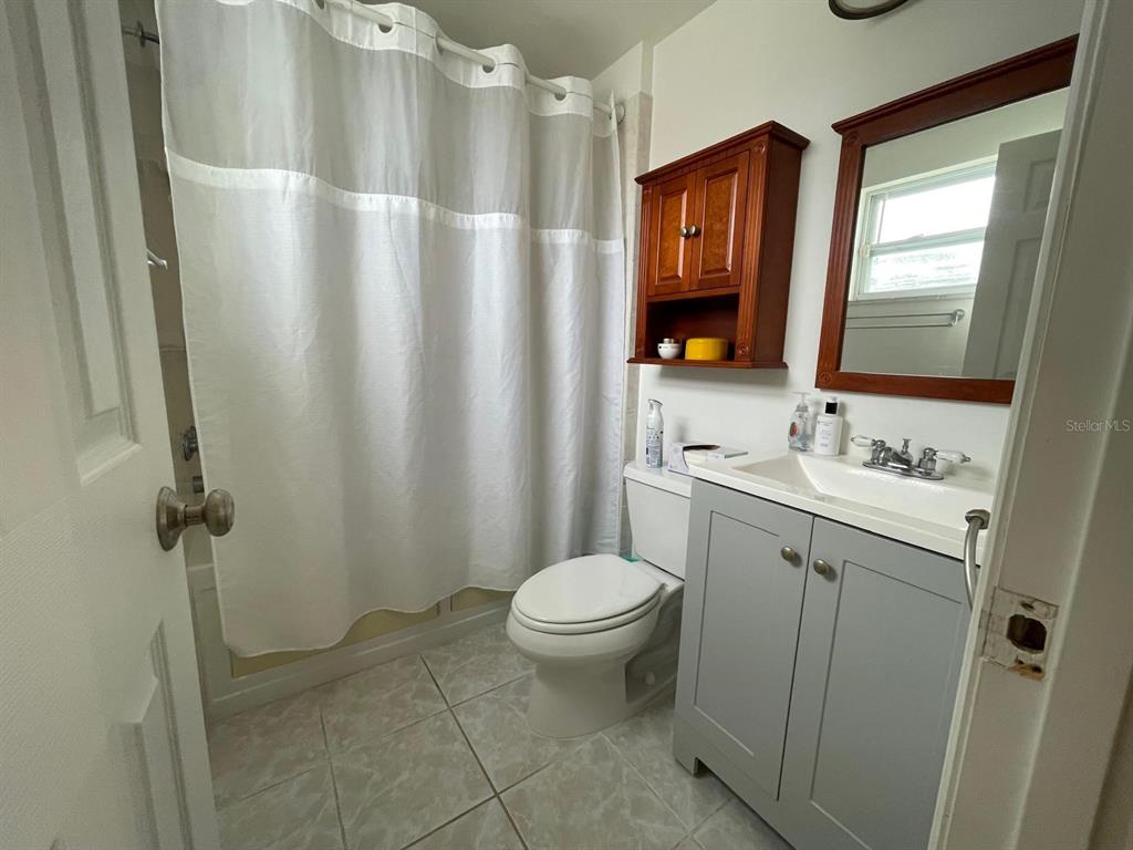 6314 Seabreeze Drive Port Richey, FL 34668 - Photo 24 of 46 a bathroom with a granite countertop sink toilet and shower