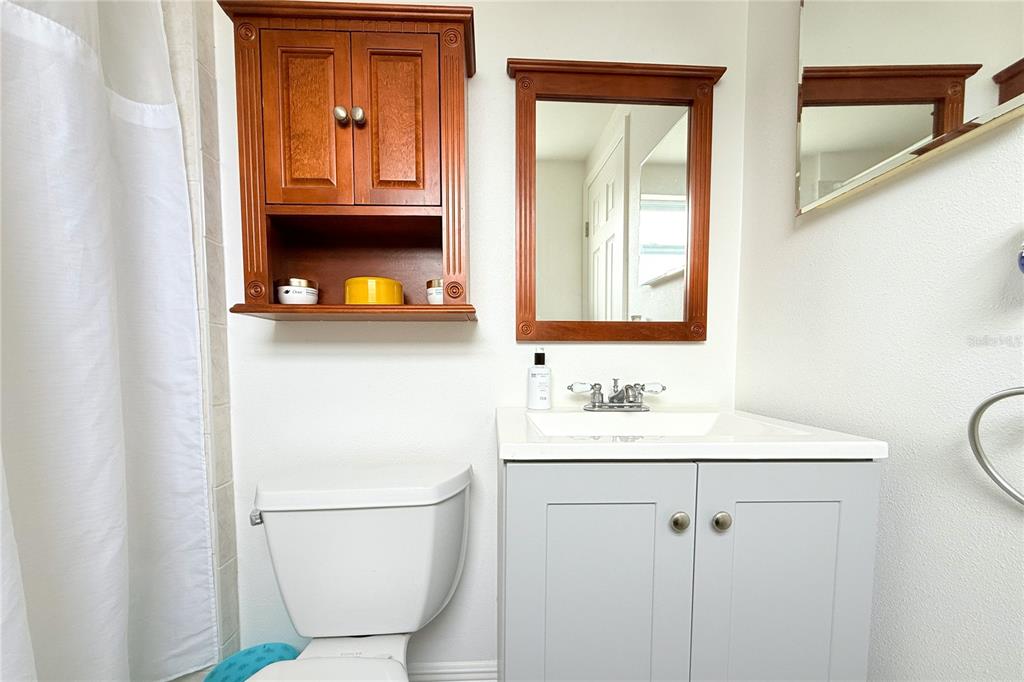 6314 Seabreeze Drive Port Richey, FL 34668 - Photo 25 of 46 a bathroom with a toilet a sink and mirror