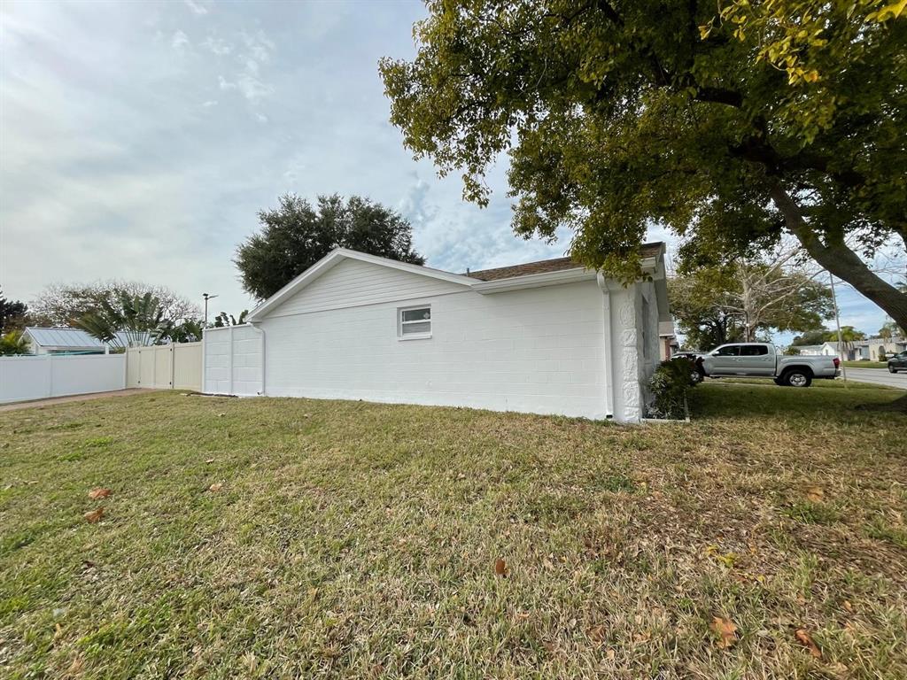 6314 Seabreeze Drive Port Richey, FL 34668 - Photo 36 of 46 a view of a house with a yard