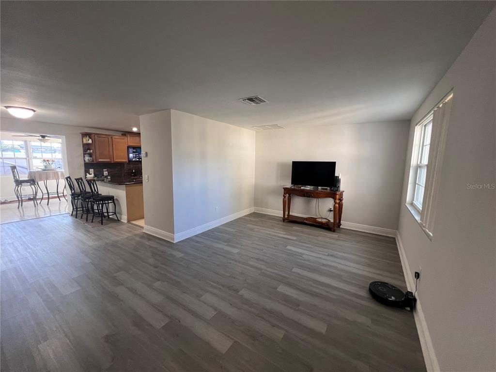 6314 Seabreeze Drive Port Richey, FL 34668 - Photo 7 of 46 a living room with furniture and wooden floor