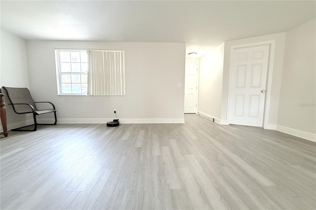 6314 Seabreeze Drive Port Richey, FL 34668 - Photo 8 of 46 an empty room with wooden floor and windows