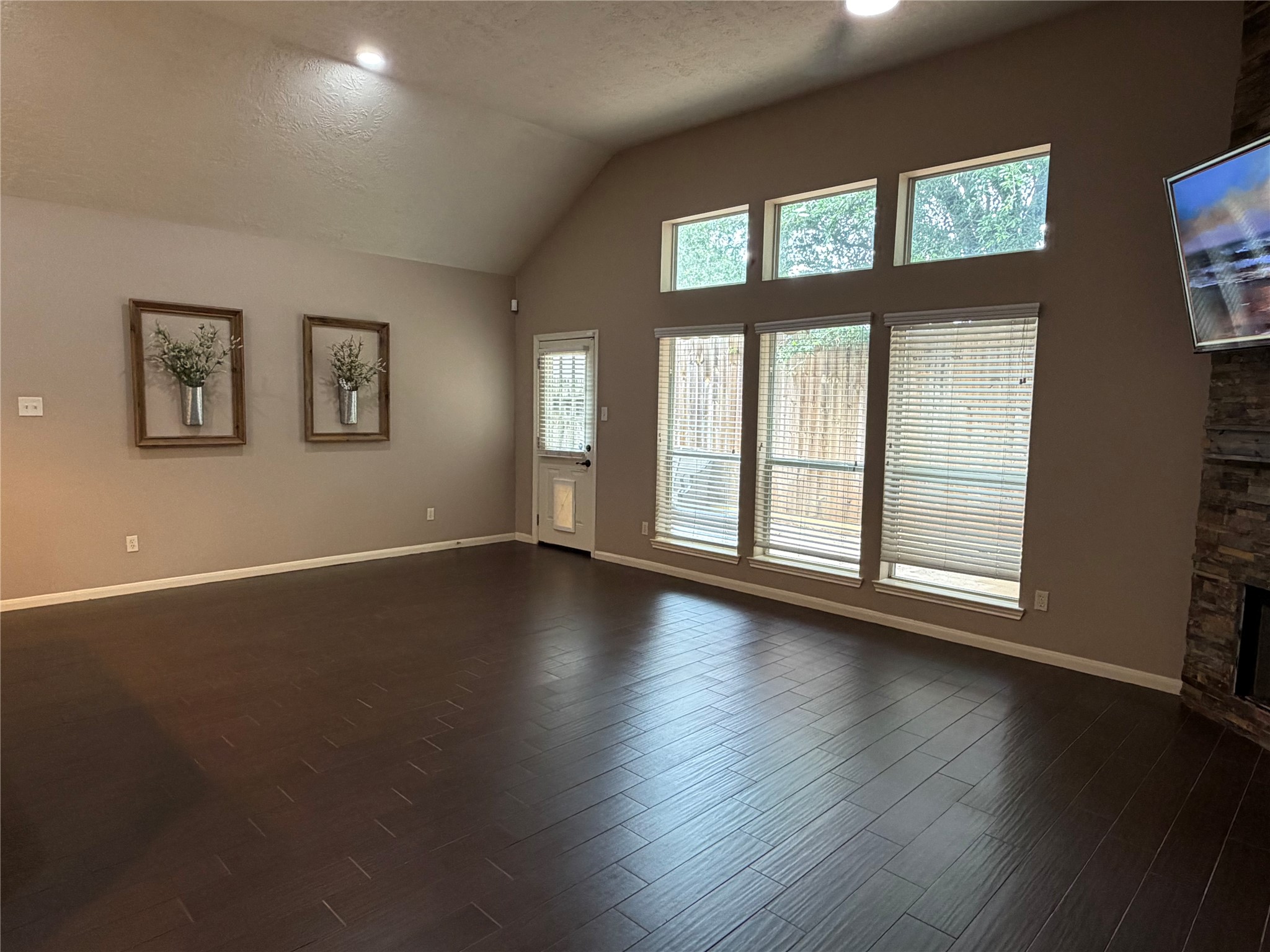 903 Cascade Ridge Katy, TX 77494 - Photo 6 of 24 a view of an empty room with wooden floor and a window