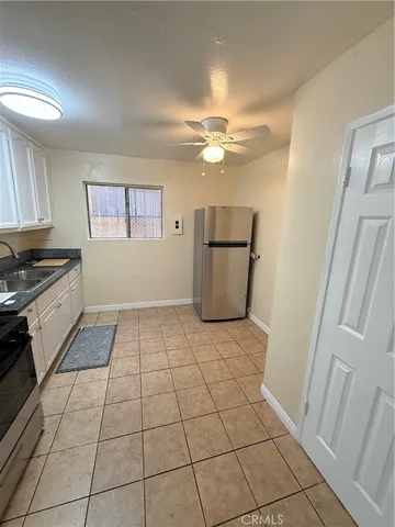 a view of a kitchen with a sink and a stove top oven