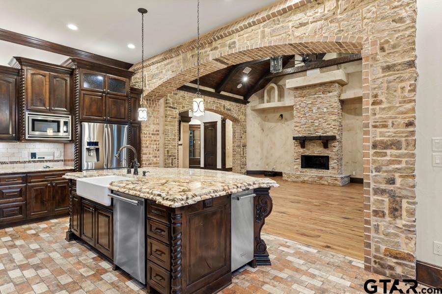 11378 Highway 110 Tyler, TX 75704 - Photo 23 of 42 a open kitchen with stainless steel appliances granite countertop a sink stove and refrigerator