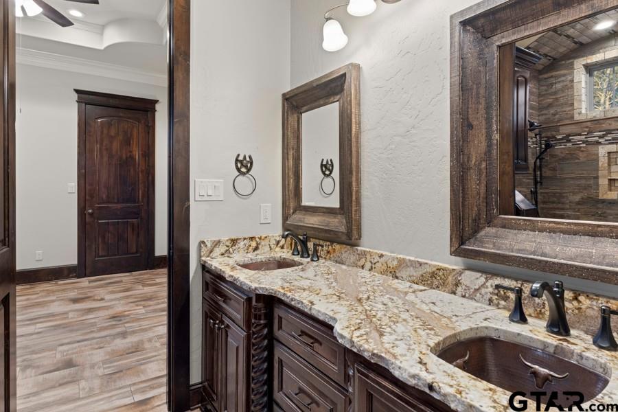 11378 Highway 110 Tyler, TX 75704 - Photo 5 of 42 a bathroom with a granite countertop sink a mirror and vanity