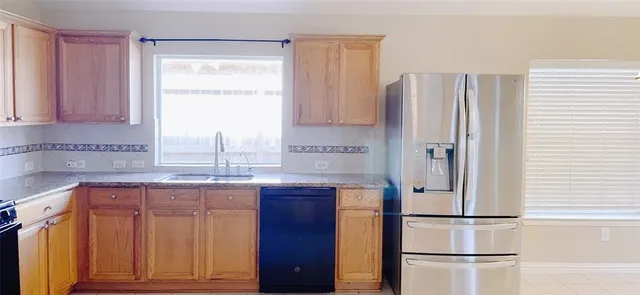 a kitchen with stainless steel appliances granite countertop a refrigerator and a sink
