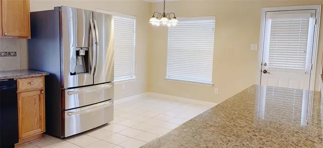a view of a room with wooden floor and a window