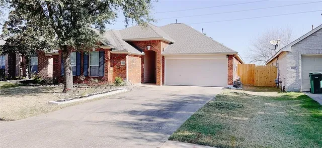 a view of a house with a yard and garage
