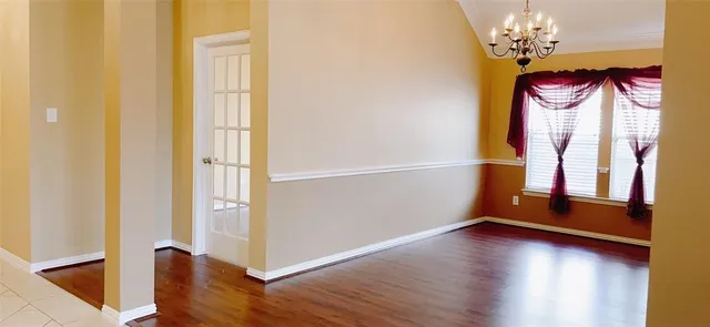 a view of entryway with wooden floor and chandelier