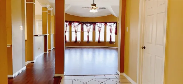a view of a room with wooden floor and door