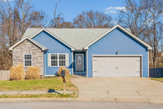 a view of a house with a yard covered in snow