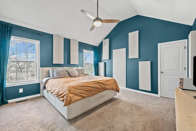 a bedroom with a bed dresser and a window